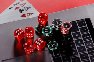 online-poker-casino-theme-gambling-chips-with-dices-and-playing-cards-close-up